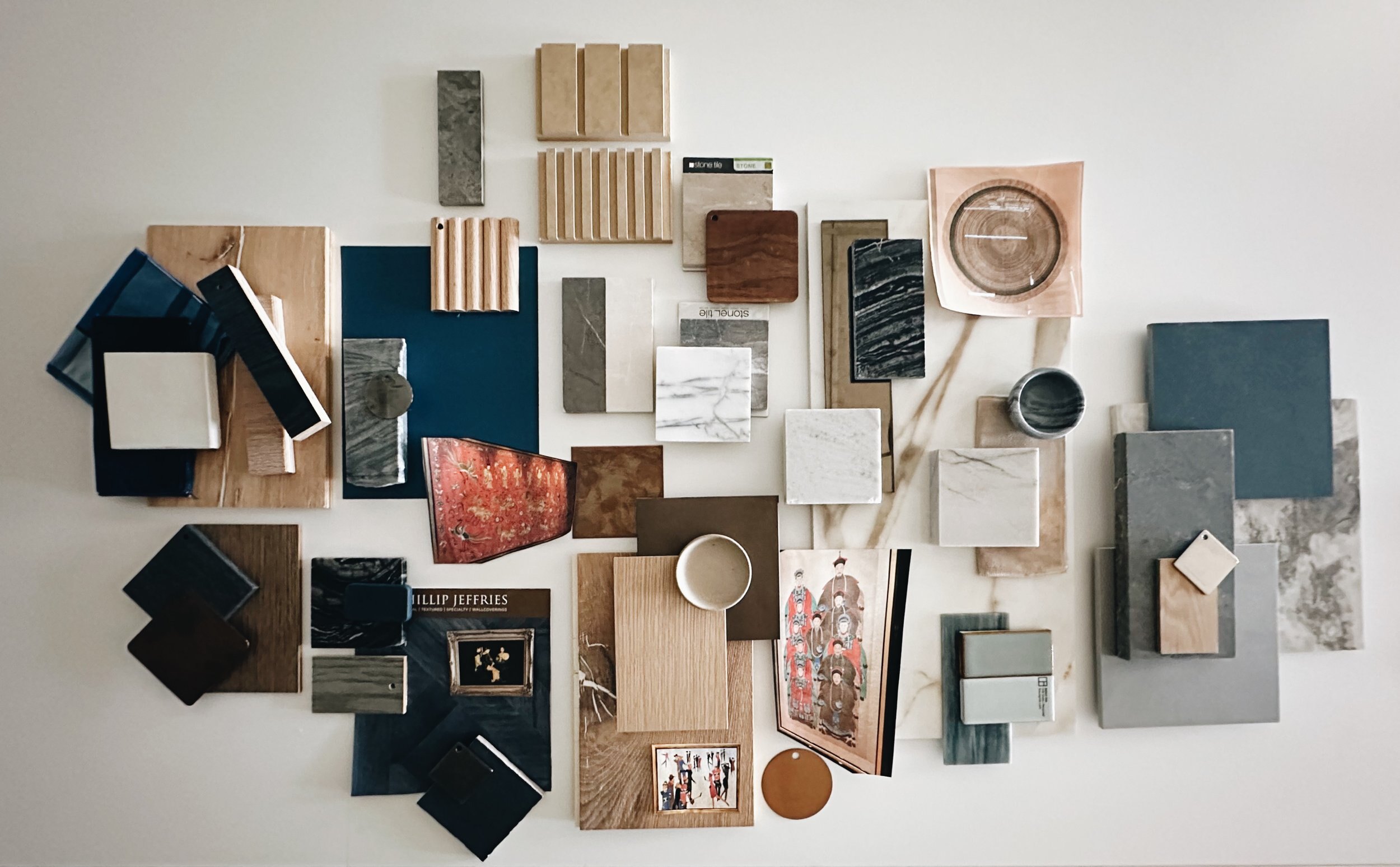 Interior material mood board with wood, stone, tile, colour and decor samples curated before room execution.