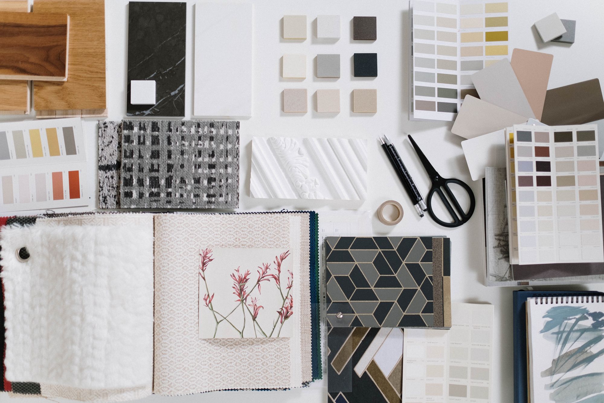 Interior design moodboard with wood, stone, fabric, colour palettes and drawing tools used by Inest Interiors to visualise a room before execution.
